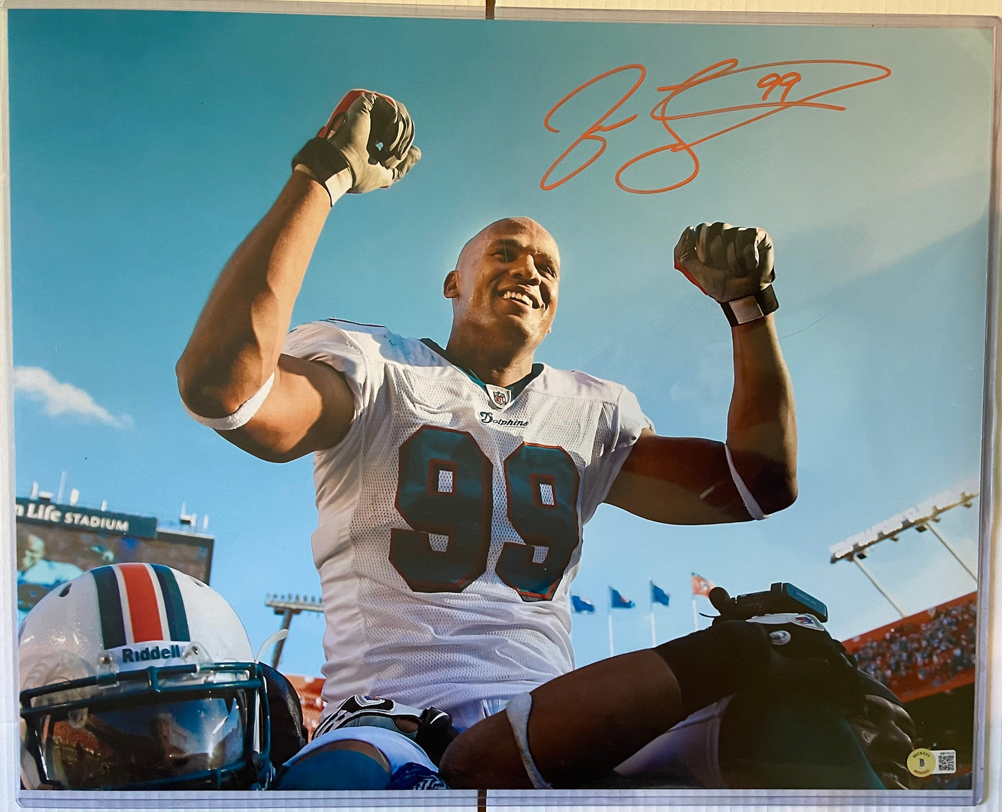 Jason Taylor Dolphins Autographed Football 16x20 Photo with Beckett COA